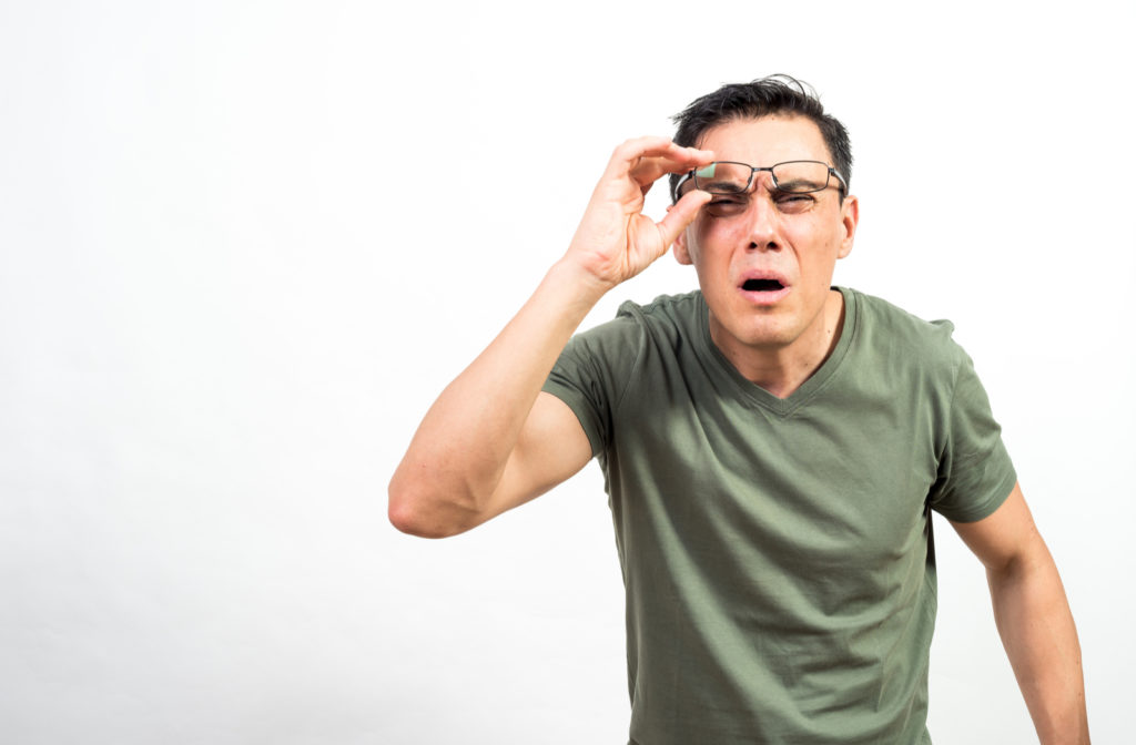 Man with nearsightedness or myopia squinting to see in distance