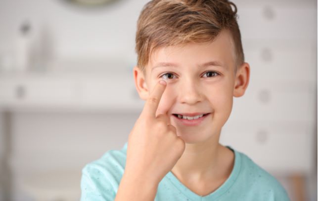 Young boy wearing ortho-k contact lenses to help control myopia progression