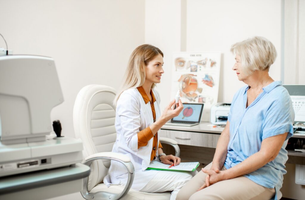 A senior talks to their optometrist to prep for cataract surgery, learning how to use eye drops post-surgery.