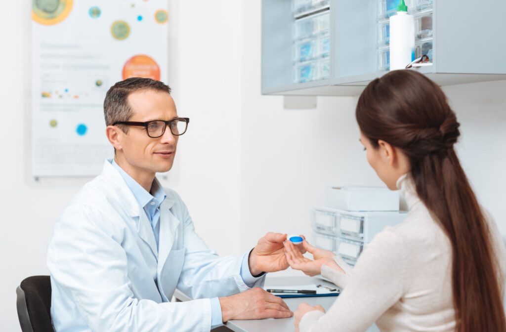 An optometrist clarifies proper contact lens wear and care during a patient's annual contact lens fitting.