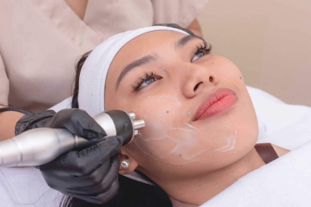 Young woman getting RF treatment on her face